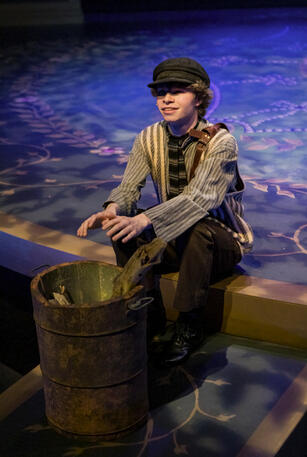 Actors: Daniel Mercado; Props: Leather Satchel, Fire Barrel with interior lighting.