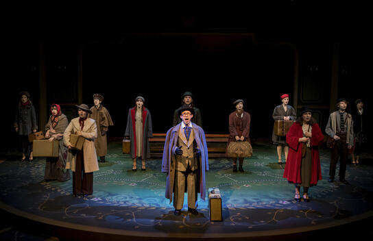 Actors: Carson Wong, Ensemble; Props: Leather Satchel, Suitcases, Carpet Bag, Train Benches.